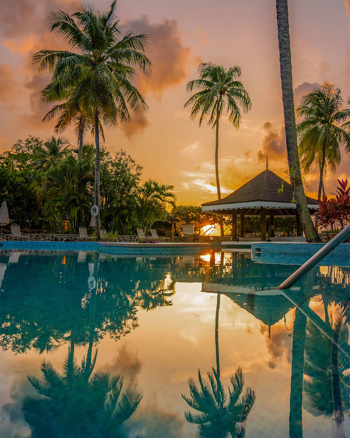 Beautiful Sundown with Palms over Pool